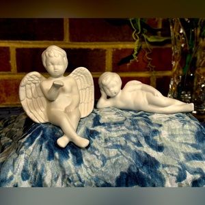 A pair of angels. The sitting angel is around 4” tall and one laying is 4” long